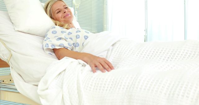 Smiling Female Patient Recovering in Hospital Bed - Download Free Stock Images Pikwizard.com