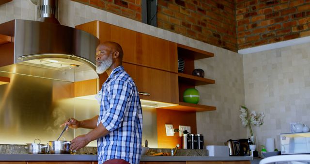 Senior Man Cooking in Modern Kitchen with Brick Wall Feature - Download Free Stock Images Pikwizard.com