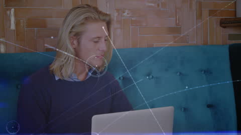 Man Engaged with Laptop and Futuristic Digital Interface Animation