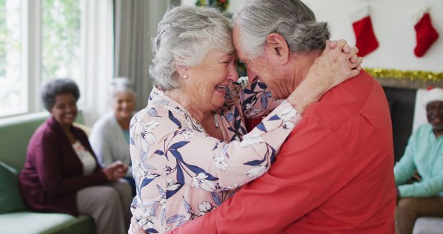 Senior Couple Embracing Joyfully in Christmas Living Room - Download Free Stock Images Pikwizard.com