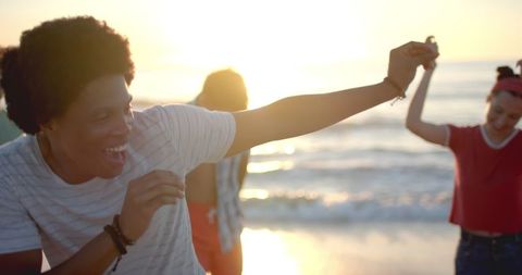 Happy Friends Having Fun at Sunset Beach