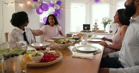 Family Celebrating Special Occasion with Festive Meal and Decorations