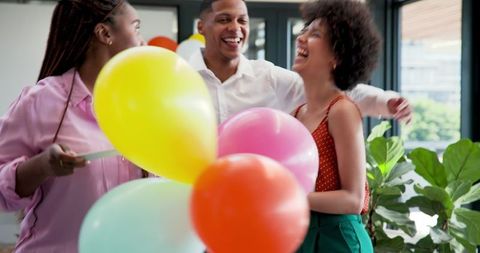 Diverse Colleagues Enjoy Laughter After Elevator Celebration