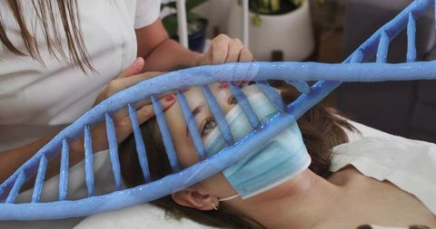 Clinician performing masked facial therapy with dna helix overlay representing genetic wellness