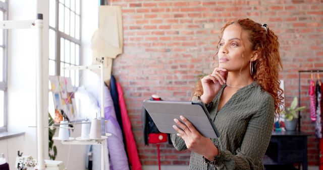 Fashion Designer Holding Tablet Planning New Collection in Studio - Download Free Stock Images Pikwizard.com