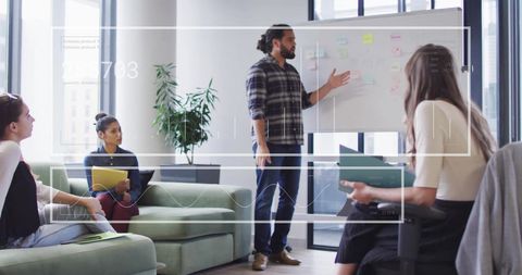 Diverse Team Collaborating with Digital Data Integration in Office