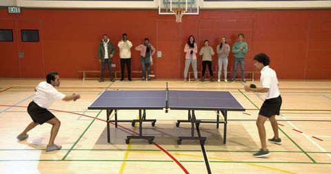 Competitive Table Tennis Match in Community Gymnasium