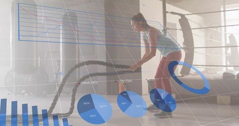 Female athlete swinging battle ropes with data overlay in boxing gym training analytics