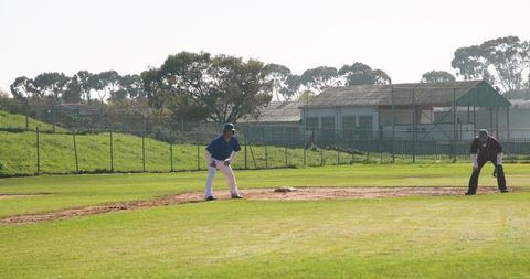 Baseball players strategically positioned on field