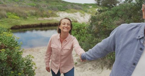 Happy Senior Couple Enjoying Riverside Walk Outdoors