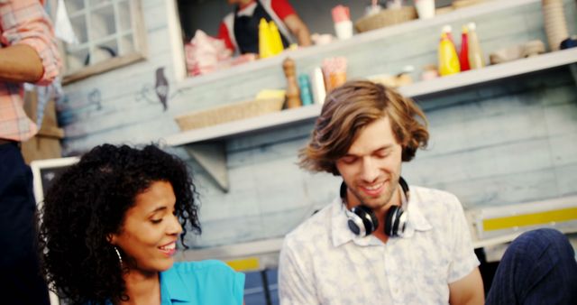 Young Friends Enjoying Conversation Near Food Stand - Download Free Stock Images Pikwizard.com