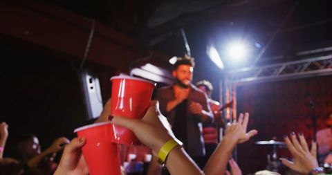 Energetic Concert Scene with Party Cups