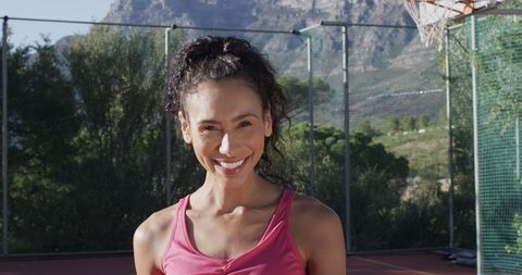 Joyful Female Athlete on Outdoor Basketball Court