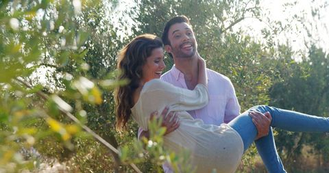 Joyful Couple Embracing Outdoors in a Natural Green Space - Download Free Stock Images Pikwizard.com