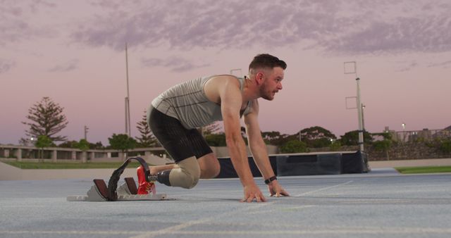 Para-athlete preparing for track sprint at sunset - Download Free Stock Images Pikwizard.com