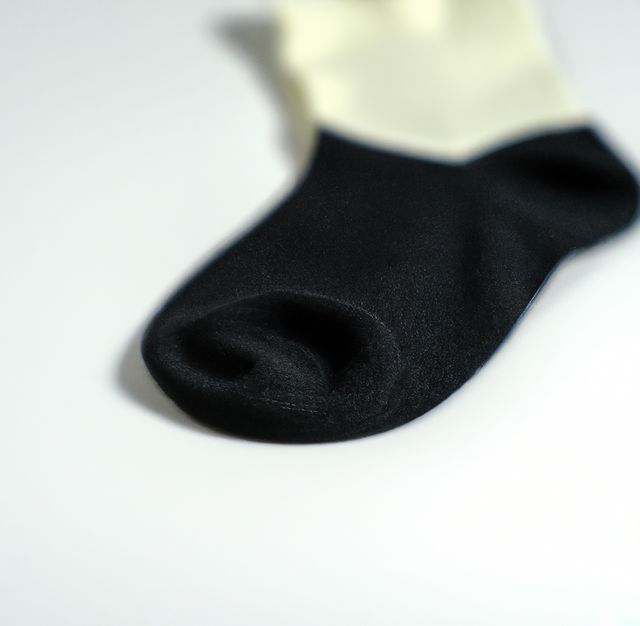 Close-Up of Black and White Sock on White Background - Download Free Stock Images Pikwizard.com