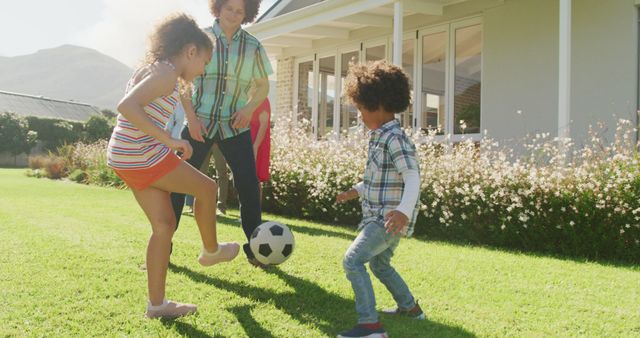 Family enjoying quality time playing soccer in the backyard. Ideal for themes around outdoor activities, family bonding, parenting, and promoting active lifestyles during summertime.