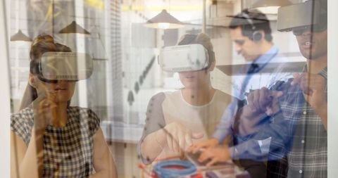 Diverse Team Using Virtual Reality in Modern Office Environment