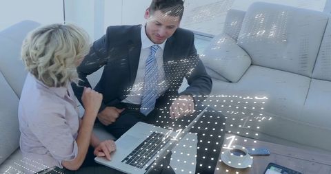 Business Professionals Engaging in Data Discussions with Computer