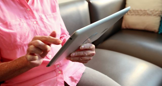 Senior Woman Using Tablet, Sitting on Couch at Home - Download Free Stock Images Pikwizard.com