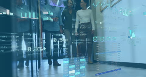 Diverse Business Team Analyzing Digital Data Projections in Office Corridor