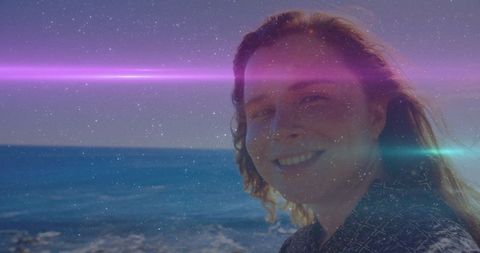 Joyful Woman with Lens Flare by Sea on Sunny Day