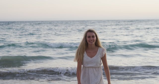 Smiling woman enjoying beach sunset in white summer dress - Download Free Stock Images Pikwizard.com