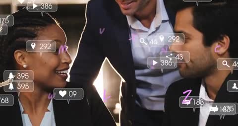 Business Team Leaning Over Laptop While Social Media Metrics and Analytics Overlays Float