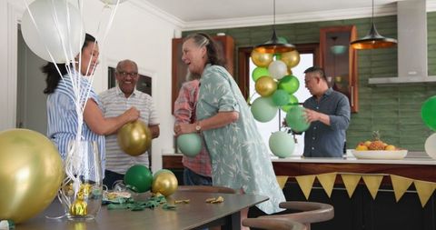 Seniors Celebrating at Home with Festive Balloons and Decorations