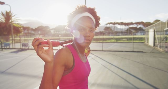 Confident Female Tennis Player on Court Holding Racket - Download Free Stock Images Pikwizard.com