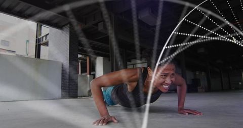 Woman exercising in abandoned warehouse with digital dna overlay
