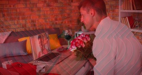 Virtual romance: man presents flowers during online video call