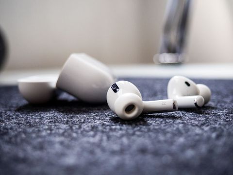 Close-up of technology wireless earbuds on textured fabric
