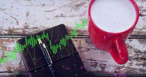 Red coffee mug and leather notebook resting on rustic wood with stock chart overlay