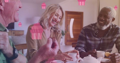 Joyful Seniors Enjoying Tea at Home with Cupcake Graphics