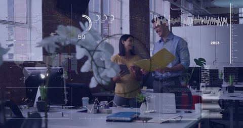 Two colleagues collaborating over analytics dashboard in open office with orchid and hud