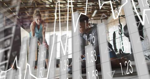 Workout partners resting and checking phone in warehouse gym with fitness data overlay