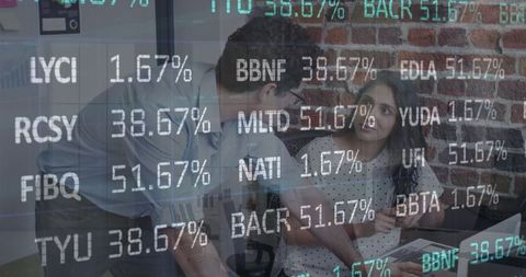 Office team analyzing stock market data on screens