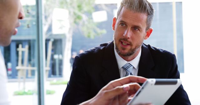 Businessman Discussing Project on Tablet in Modern Office - Download Free Stock Images Pikwizard.com