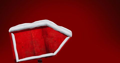 Snow-covered Wooden Signboard on Red Background