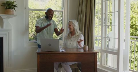 Happy Couple Sharing Morning Coffee in Bright Living Room