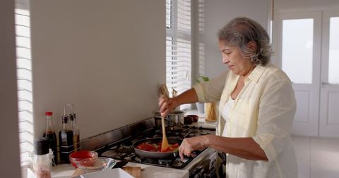 Senior Woman Preparing Healthy Vegetable Dish in Kitchen