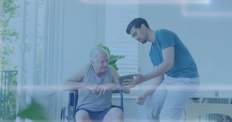 Biracial Nurse Assisting Wheelchair User with Tablet