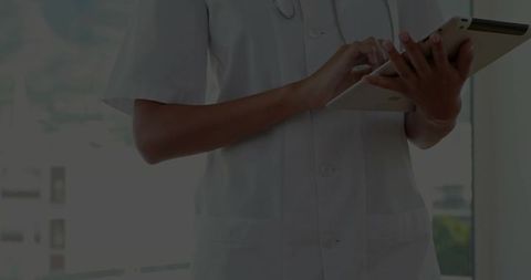 Healthcare professional using tablet in modern clinic