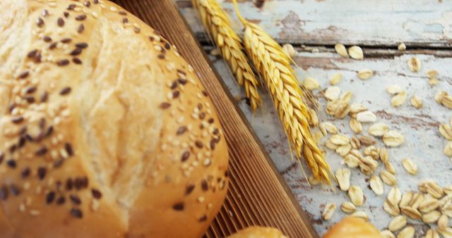 Freshly Baked Bread with Wheat and Oats on Rustic Wooden Table - Download Free Stock Images Pikwizard.com