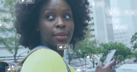 Woman Engaging with Social Media in Urban Environment