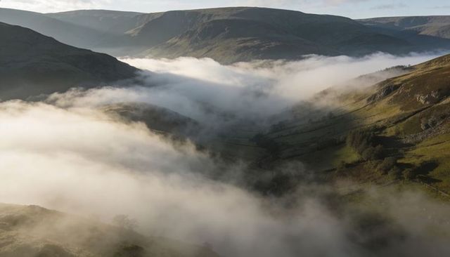 Dawn Fog Filling Upland Valley with Rolling Mist, Rocky Ridges and Stone Walls