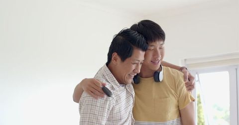 Father and Young Son Sharing Joyful Moment Together at Home