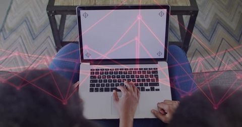Mother and daughter collaborating on laptop, typing and connecting via red network overlay
