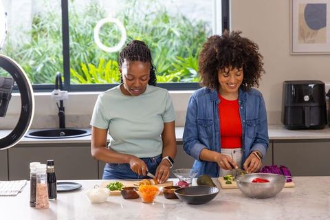 African American Women Collaborating on Healthy Meal Prep in Bright Home Kitchen